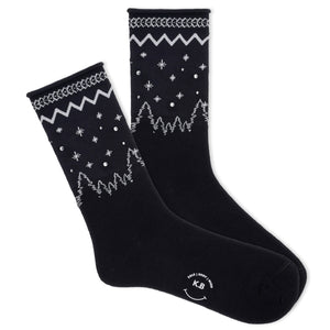 A pair of K.Bell women's roll-top crew socks with a winter sparkle design, featuring star patterns on a black background.