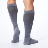 Back profile of a man wearing a pair of gray over the calf compression Dr. Scholl's socks. thumbnail