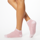 Person wearing pink two-toned tonal fuzzy Dr. Scholl's soothing spa socks.