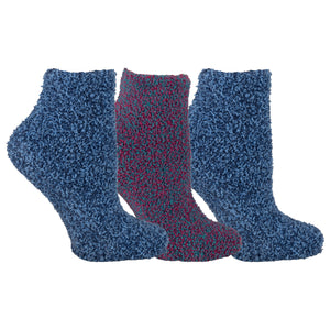 Three pairs of fuzzy socks in blue and red on a white background