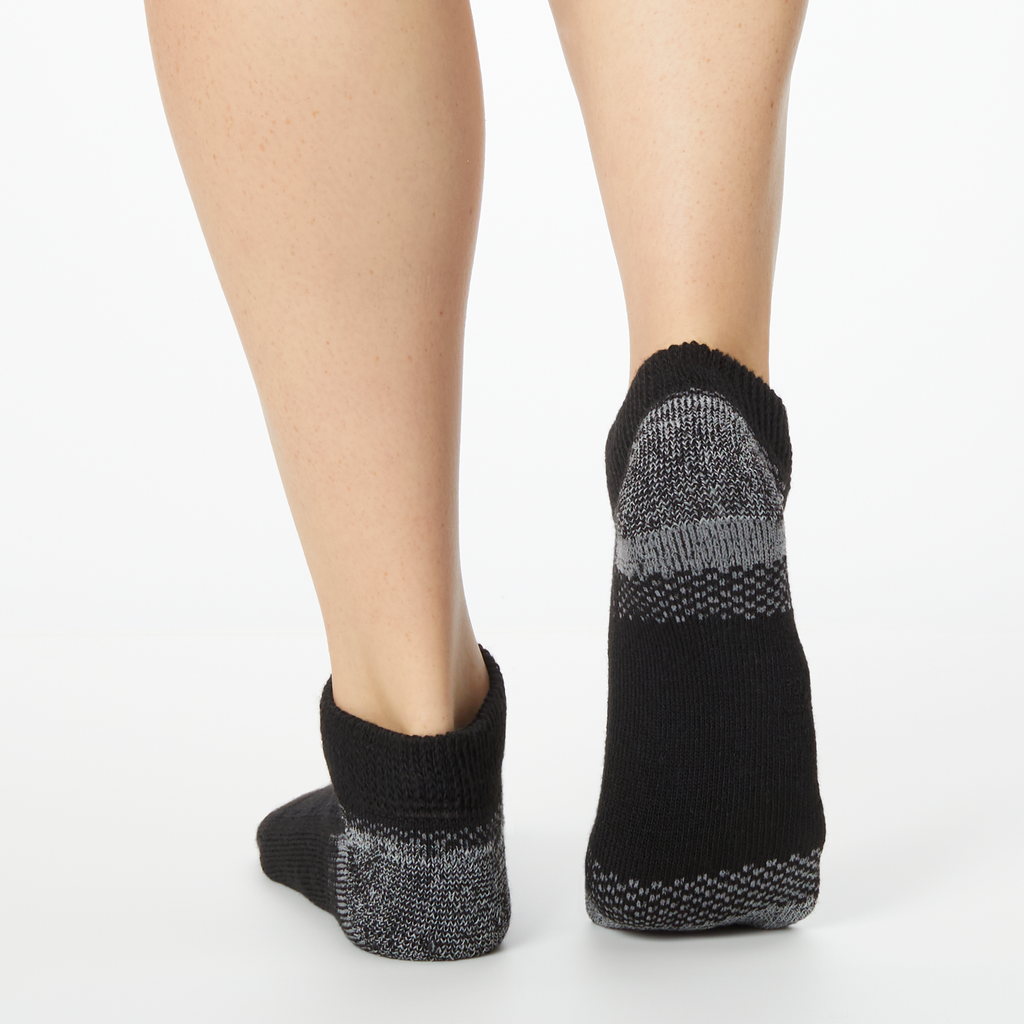 Person wearing black Dr. Scholl's ankle socks with gray accents