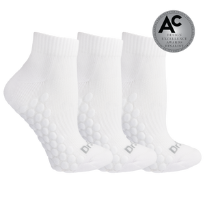 Three white ankle socks with raised bubble grip panels on the sole, shown on a white background with a silver award badge in the top right.