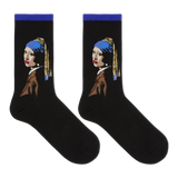A pair of black crew socks featuring a stylized graphic of Vermeer's Girl with the Pearl Necklace, shown against a plain white background.