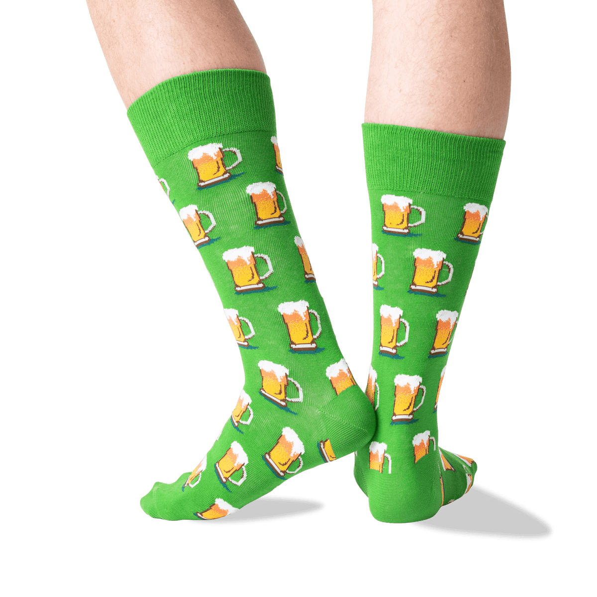 A pair of bright green crew socks with an all-over repeating pattern of beer mugs, shown worn on a person's legs against a clean white background.