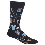 A single crew sock on a plain white background, featuring a dark charcoal/black base with a medical-themed pattern of light blue scrubs, a stethoscope, white gloves, and pill bottles with orange details.