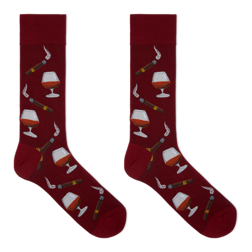 A pair of crew socks in deep burgundy with a repeating pattern of cigars, smoking pipes, and cognac glasses filled with amber liquid, shown on a plain white background.