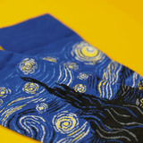 Blue socks with starry night design on a yellow background thumbnail