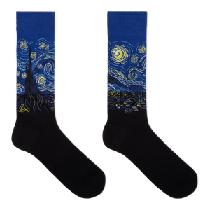A pair of crew socks featuring a blue and yellow Van Gogh-inspired swirling night sky and cypress tree design on the upper portion, with solid black feet below, shown on a plain white background.