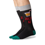 A pair of novelty crew socks worn on a person's feet, featuring a dark charcoal body with red text reading 'JOLLY AF', a cocktail graphic, a gray cuff, and teal toes and heels.