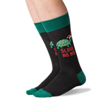 A pair of crew socks worn on a person's legs, featuring a dark charcoal gray body with a green turtle wearing a Santa hat and the text 'SLOW HO HO' in red, plus green cuffs, heels, and toes. thumbnail