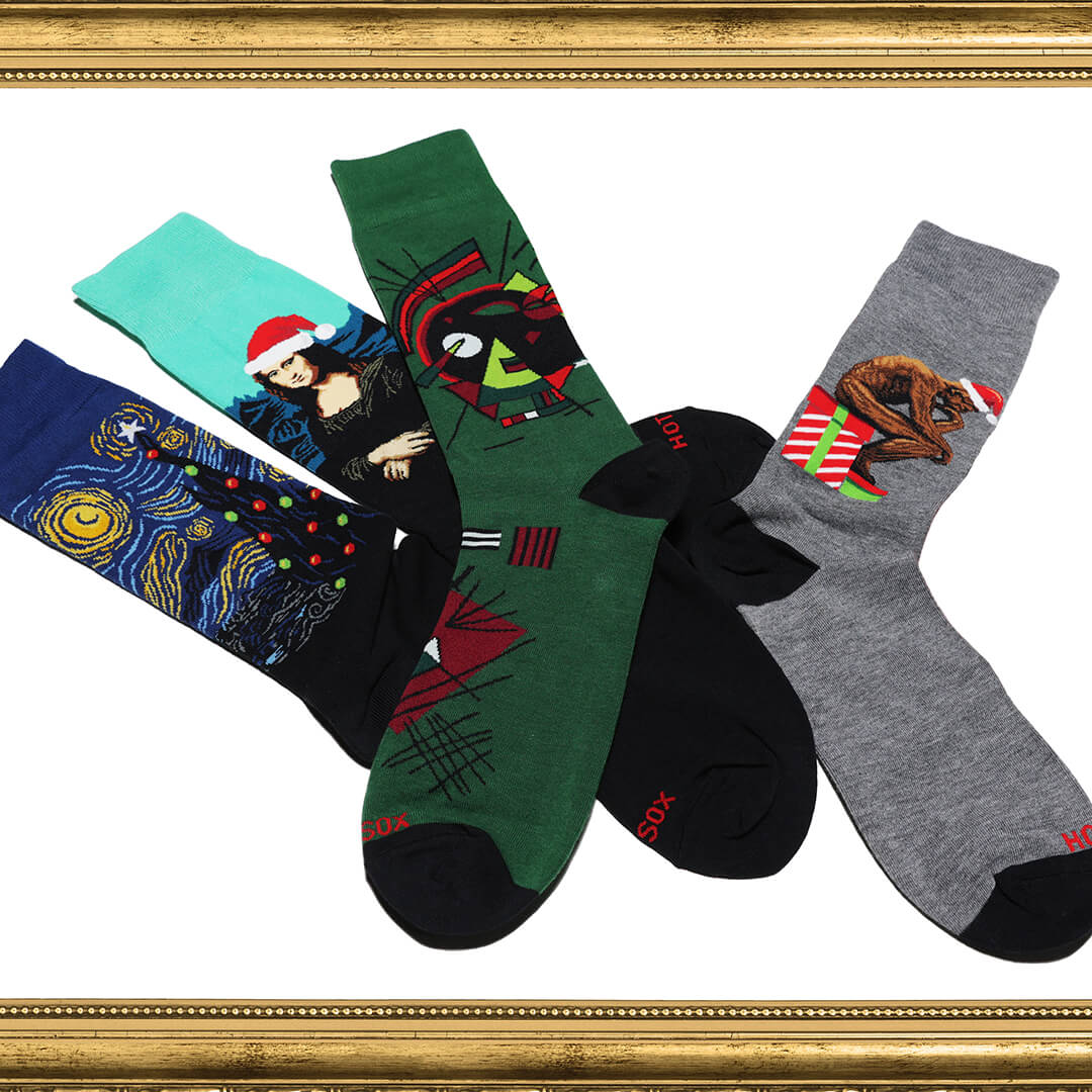 Four pairs of socks with artistic designs on a white background