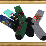 Four pairs of socks with artistic designs on a white background