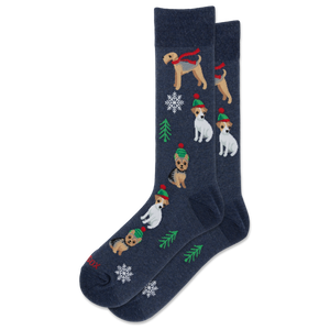 A pair of navy blue crew socks featuring a festive Christmas pattern with wirehaired dogs wearing red scarves and green hats, decorated with white snowflakes and green pine trees.