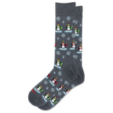 A pair of dark gray crew socks featuring a repeating pattern of penguins wearing red and green hats and scarves, standing on icy blue platforms with white snowflakes.