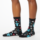 Woman wearing black socks with a repeat medical pattern