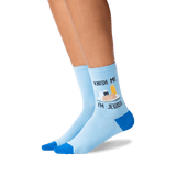 Light blue crew socks with blue toes, heels, and soles, featuring a graphic of a Passover Seder plate with the text 'KNISH ME, I'M JEWISH' worn on a model's feet against a white background. thumbnail