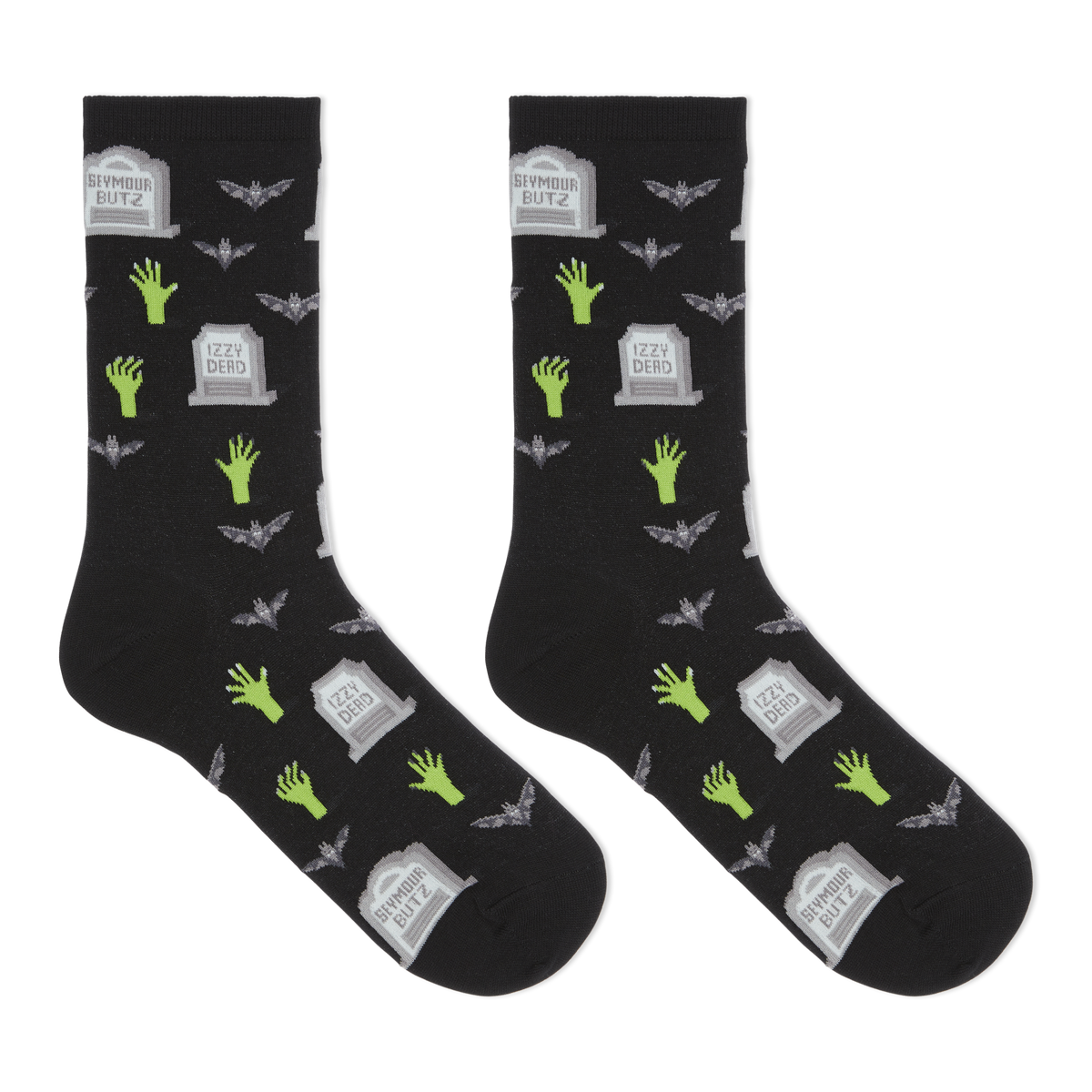 A pair of black crew socks with a Halloween-themed print featuring green zombie hands, gray tombstones, and gray bats, displayed against a solid white background.