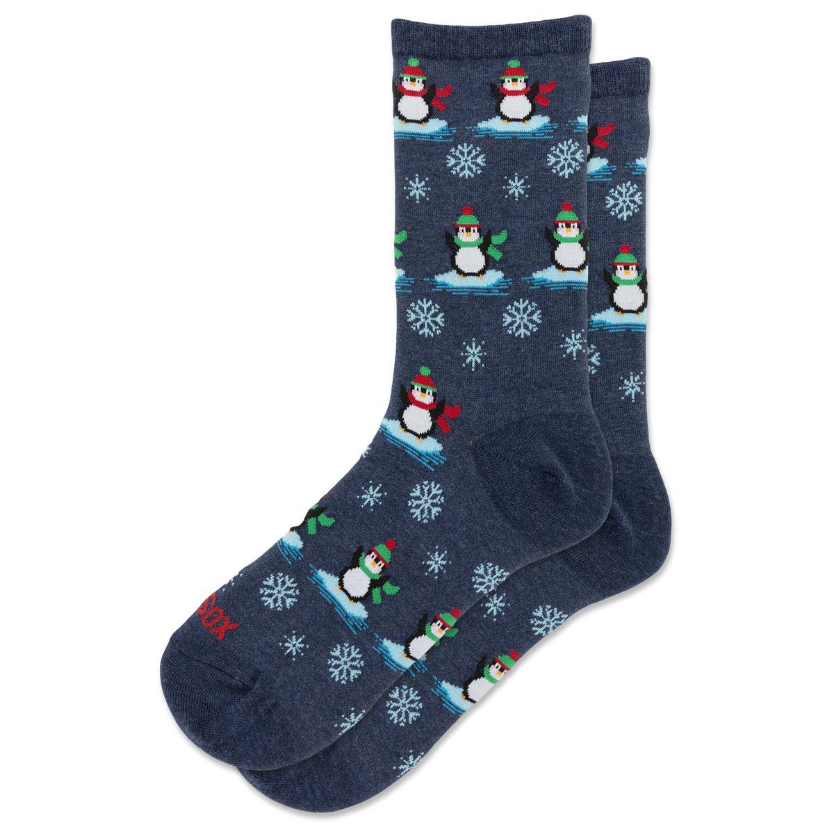 A pair of navy blue crew socks with a repeating pattern of penguins on ice, snowflakes, and small red accents.
