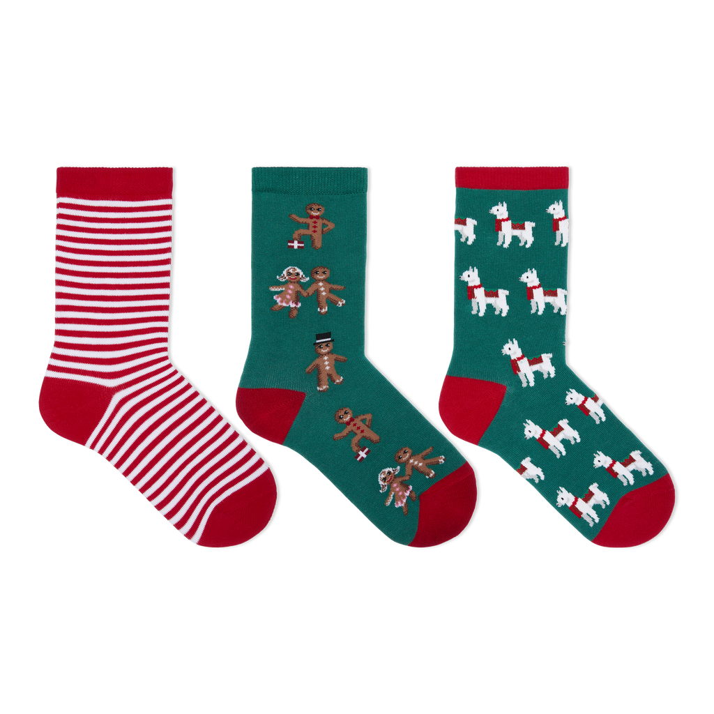 Three pairs of Christmas-themed crew socks displayed side-by-side on a plain white background. The left pair features red and white horizontal stripes with a red toe and heel.