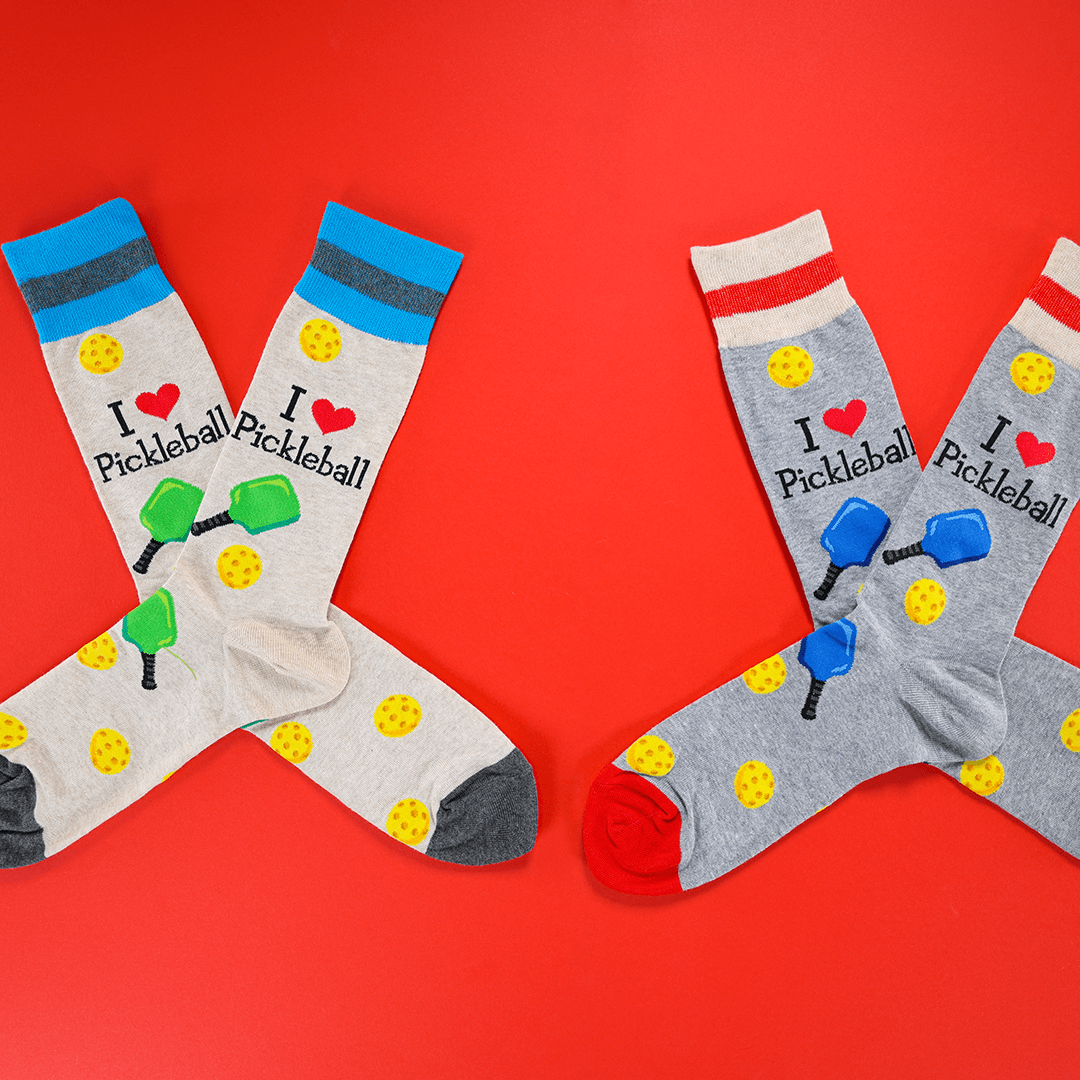 Two pairs of pickleball-themed socks on a red background