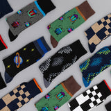 Collection of colorful mens socks with various patterns on a light gray background