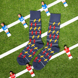 Two pairs of socks with a unique pattern on a grass field background