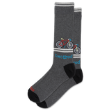 A pair of dark heather gray crew socks with black heels and toes, featuring a colorful bicycle graphic and the text 'two tired' in blue, on a plain white background.
