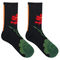 A pair of black crew socks featuring a red lotus flower and green leaf design, with a vertical orange stripe near the cuff, shown on a plain white background.