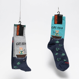 Two pairs of socks hanging on a fishing lines with labels.