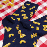 Navy blue socks with yellow pasta pattern on a red and white checkered background