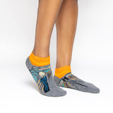 Gray and orange socks with a design inspired by 'The Scream' by Edvard Munch.