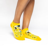 A person wearing bright yellow low-cut socks with a black, white, and gold abstract art print, shown against a plain white studio background. thumbnail