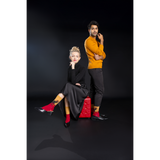 Man and woman posing together on a black background