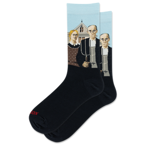A pair of black crew socks with a light blue upper cuff featuring a graphic print of Grant Woods' "American Gothic" painting. The word 'HOTSOX' is printed in red on the toe area of the front sock.
