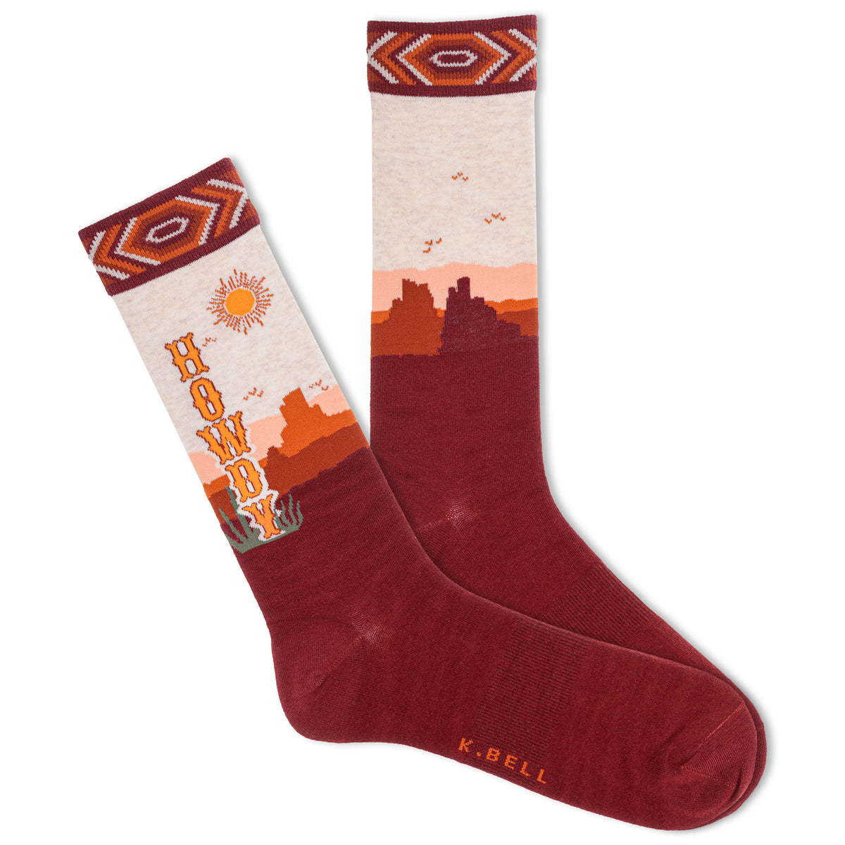 A pair of men's crew socks with a Southwestern desert landscape design, featuring the text 'HOWDY' and a sun motif, in a red color.