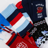 Collection of colorful socks with various patterns and text on a white background