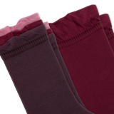 Two pairs of crew socks fanned out on a white background, with three tiers of ruffled colors from dark plum to burgundy, maroon, and dusty pink. thumbnail