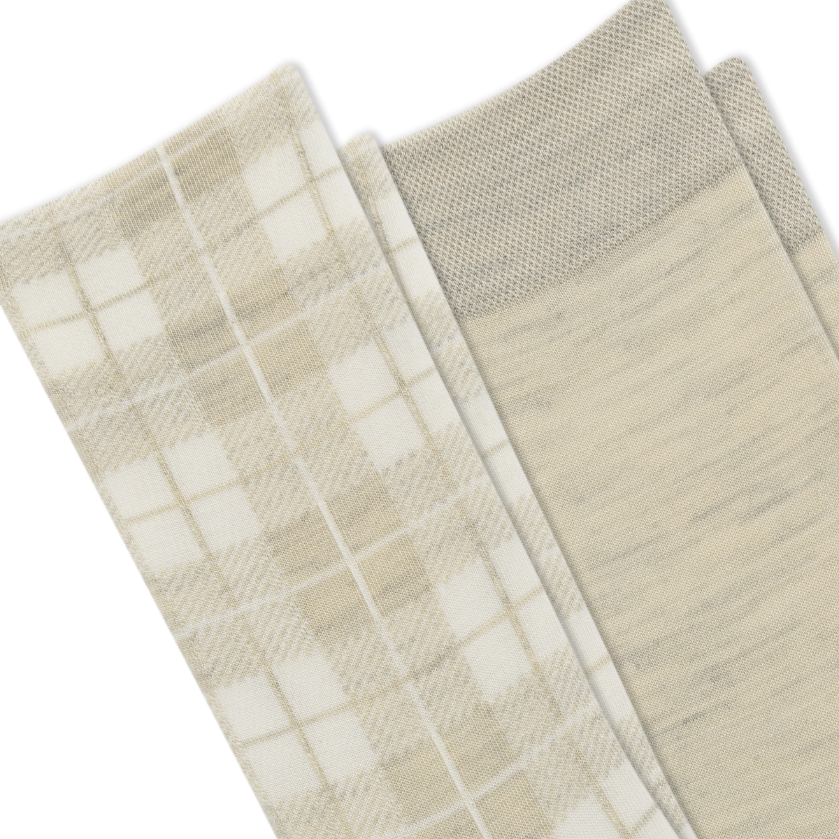 Close-up of folded socks in a soft neutral palette, showing a plaid pattern in cream and beige on one sock and a solid heathered light beige on the other, with a ribbed cuff.
