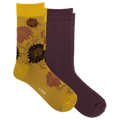 Two pairs of crew socks from K-Bell: one pair is solid dark plum purple, and the other pair is metallic gold with a floral pattern in brown and black. The yellow pair has the K-Bell brand name printed near the toe.