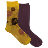 Two pairs of crew socks from K-Bell: one pair is solid dark plum purple, and the other pair is metallic gold with a floral pattern in brown and black. The yellow pair has the K-Bell brand name printed near the toe.