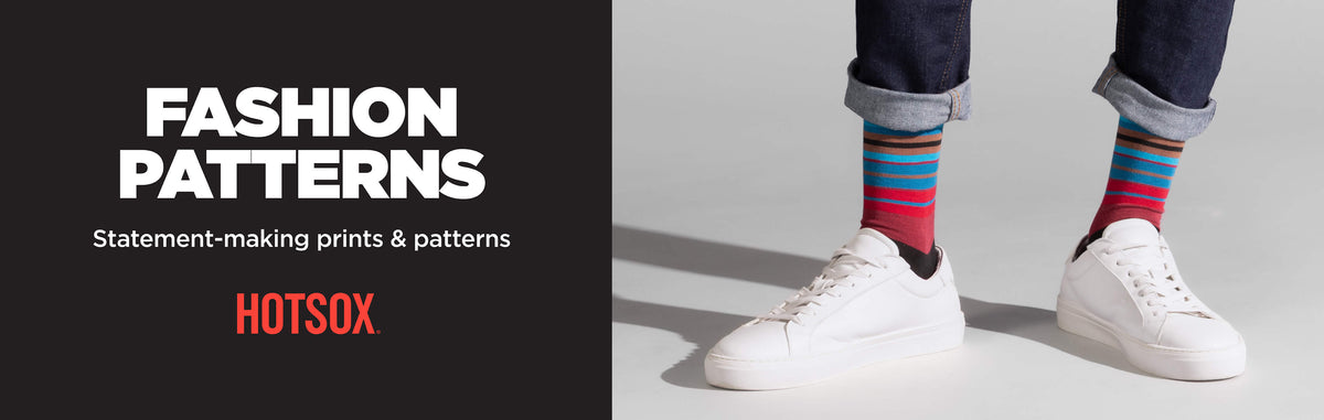 A promotional banner for HOTSOX fashion patterns, featuring a model from the knees down wearing cuffed dark jeans, colorful striped socks, and white sneakers on a light gray background.