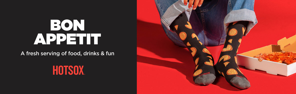 A promotional banner for HOTSOX featuring the text 'BON APPETIT' and 'A fresh serving of food, drinks & fun' on a dark gray background, alongside a person sitting on a red floor wearing black socks with a yellow pizza pattern, with a pizza box nearby.