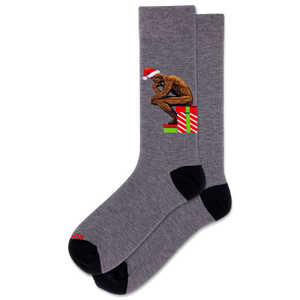 Gray sock with a Christmas-themed design featuring a figure and presents on a white background