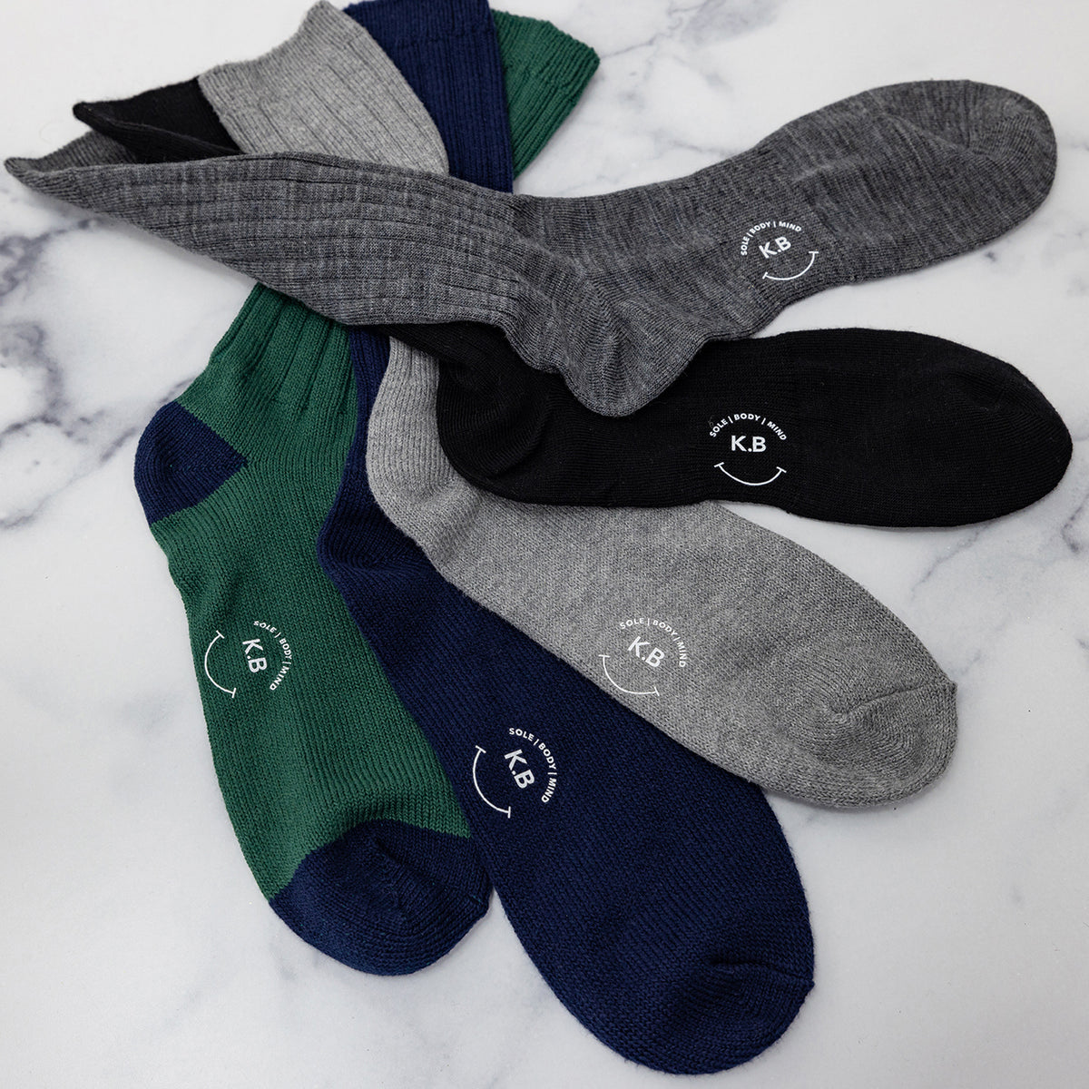 Four pairs of K.Bell men's crew socks.