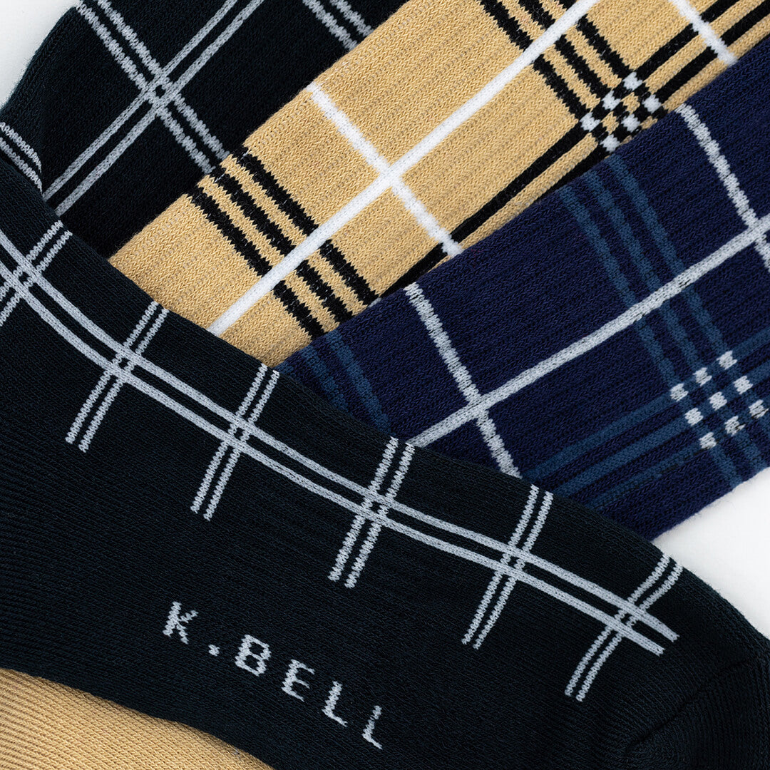 Three pairs of plaid patterned socks with 'K. Bell' branding on a white background.