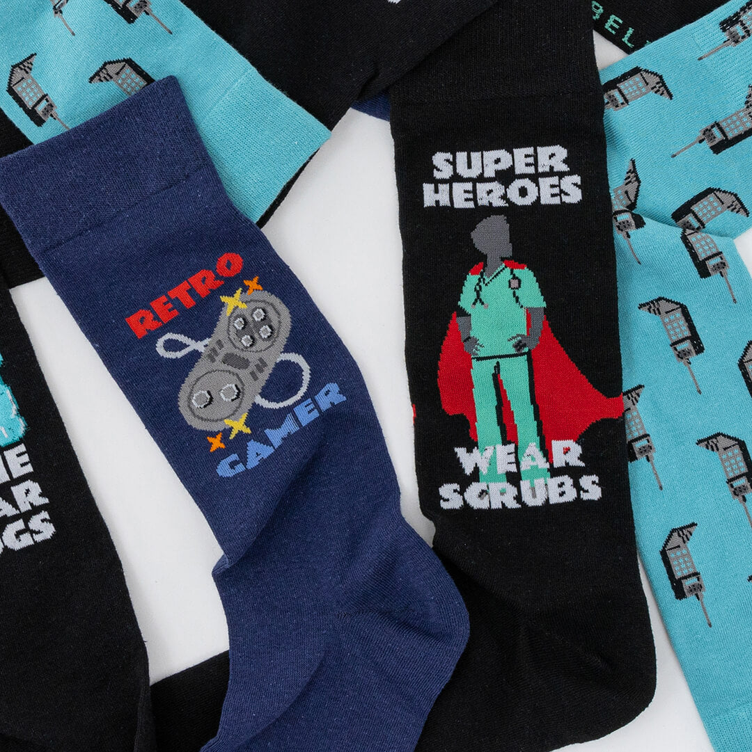 Pair of socks with 'Retro Gamer' and 'Super Heroes Wear Scrubs' designs on a white background.