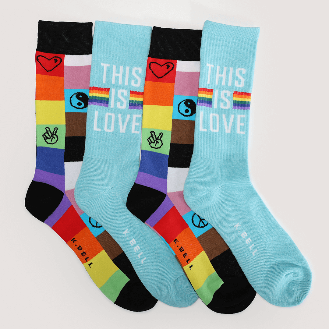 Colorful socks with rainbow patterns and 'This is Love' text on a light gray background