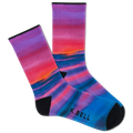 Two people wearing matching outfits with colorful socks in a casual setting.