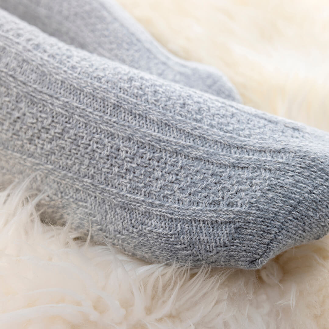 Close-up of a gray sock on a fluffy white surface