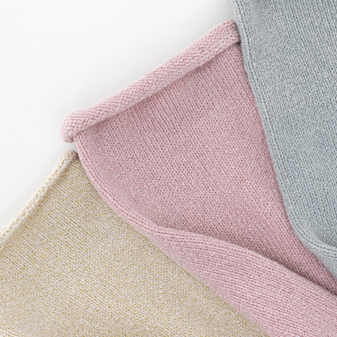 Close-up of textured pink, beige, and gray socks on a white background
